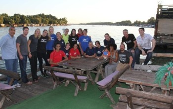 Former national team player Therese Crawford (with infant son and husband far right front row) host dinner for current national team players